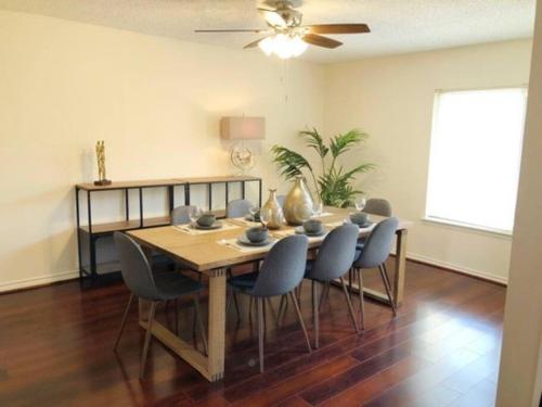 a dining room table with chairs and a ceiling fan at Entire 3 Bedroom Home Near Downtown King bed in Houston