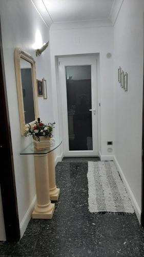 a hallway with a glass table and a mirror at Casa "Settima essenza" in Surbo