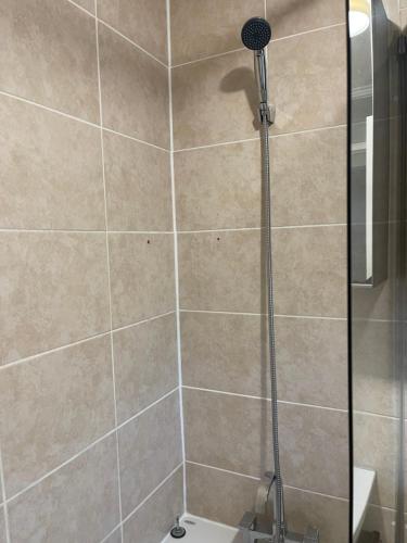 a shower with a glass door in a bathroom at NewSuites in London