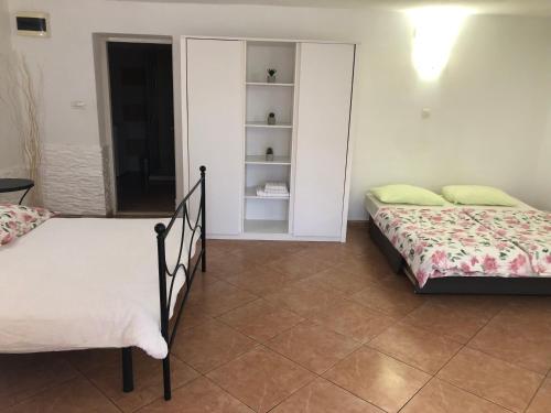 a bedroom with two beds and a closet at Apartments Roberta in Novigrad Istria