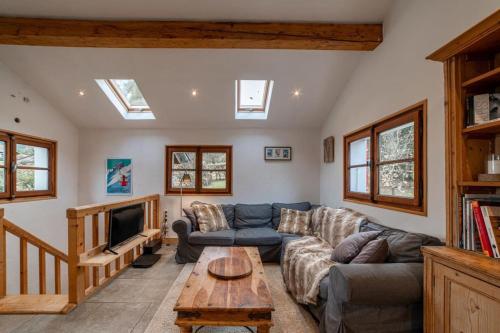 sala de estar con sofá y TV en Charming Chalet With Garden In Les Houches, en Les Houches