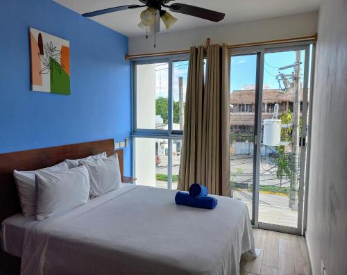 a bedroom with a bed and a large window at Cozy and spacious apartment by Tulum 10 in Tulum