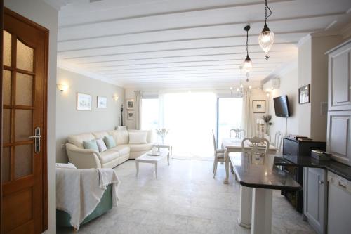 a living room with a couch and a table at Thalassaki house in Nydri