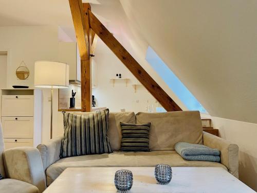 a living room with a couch and a table at Ferienwohnung im Alten Postamt in Binz in Binz