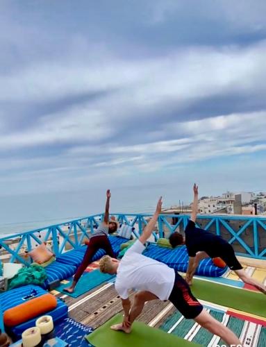 a group of people doing yoga on the deck of a cruise ship at Taghazout Ocean View in Taghazout