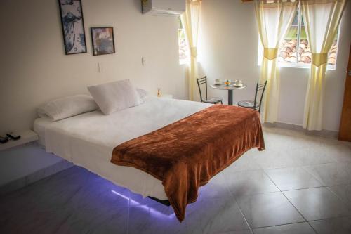 Säng eller sängar i ett rum på Hotel Lagotours