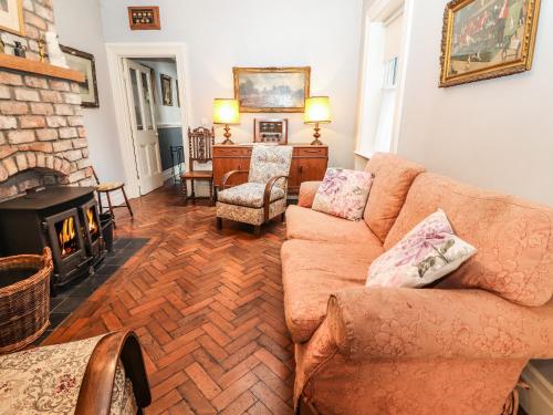 a living room with a couch and a fireplace at The Merchant's Store in Kilrush