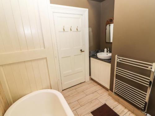 a bathroom with a white toilet and a sink at The Merchant's Store in Kilrush