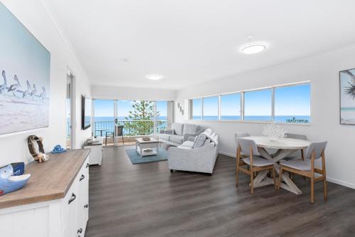 a living room with a couch and a table at Narrowneck Court Holiday Apartments in Gold Coast