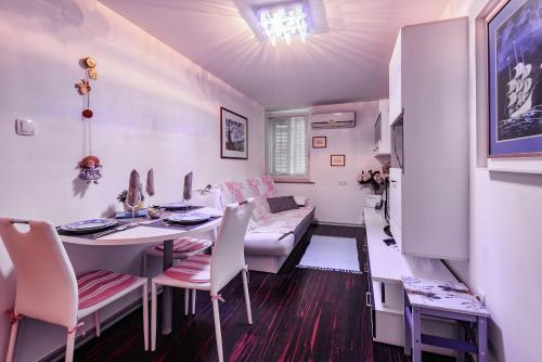 - une salle à manger avec une table et des chaises dans l'établissement MaJo Apartma Punta, à Piran