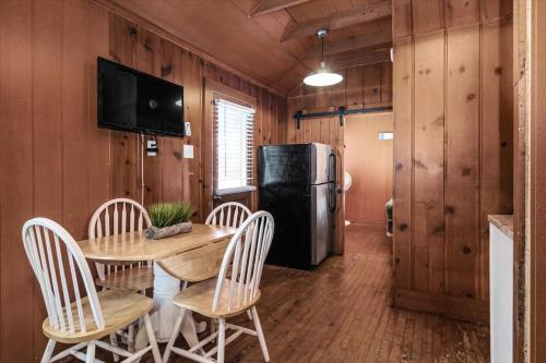 a dining room with a table and a refrigerator at Beach Bum West-O Cabins in Ocean City