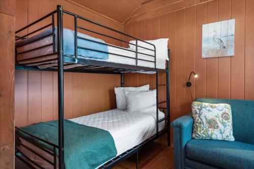 a bedroom with two bunk beds and a chair at Beach Bum West-O Cabins in Ocean City