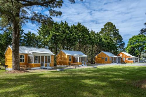 a row of wooden cabins in a park at Beach Bum West-O Cabins in Ocean City