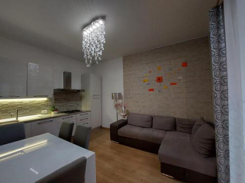 a living room with a couch and a kitchen at Appartamento nel cuore di Porto Azzurro in Porto Azzurro
