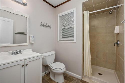 a bathroom with a toilet and a sink and a shower at Beach Bum West-O Cabins in Ocean City