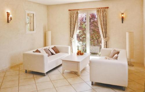 a living room with two white couches and a window at Cozy Home In Salernes With Outdoor Swimming Pool in Salernes