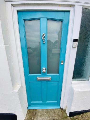 a blue front door of a building with at St Ives Balcony Flat in St Ives
