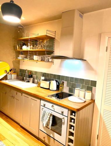 a kitchen with a stove and a sink at St Ives Balcony Flat in St Ives