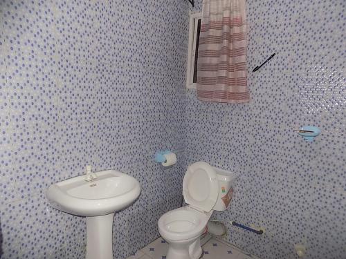 a bathroom with a toilet and a sink at Great Secured 1Bedroom Service Apartment ShortLet-FREE WIFI - Peter Odili RD - N29,000 in Port Harcourt