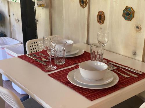 a table with plates and wine glasses on it at Private 1 Bd near Yosemite and Bass lake in Oakhurst