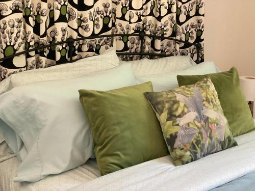 a bed with green and white pillows on it at Private 1 Bd near Yosemite and Bass lake in Oakhurst