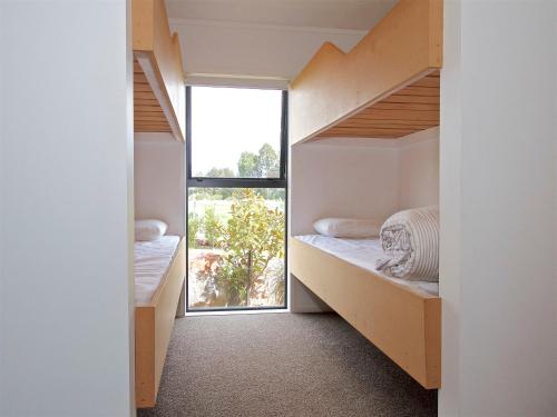 a room with two bunk beds and a window at Mountain View - Ohakune Holiday Home in Ohakune