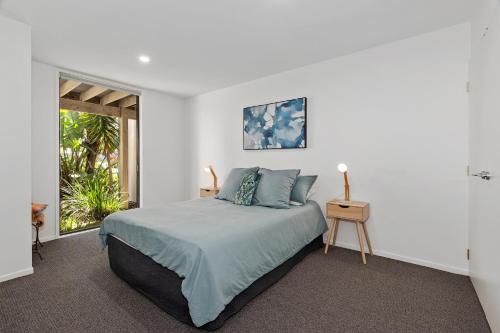 a white bedroom with a bed and a window at Harnifin - Langs Beach Holiday Home in Langs Beach