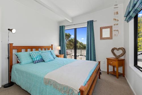 a bedroom with a bed and a window at Marina Views - Tutukaka Holiday Home in Tutukaka