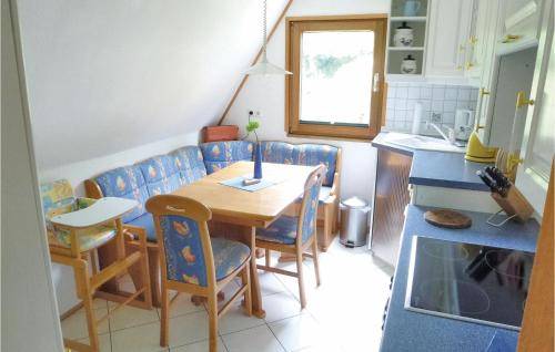 a kitchen with a table and chairs in a room at 1 Bedroom Amazing Home In Wolfshagen in Wolfshagen