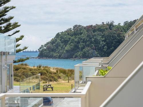 a view of the ocean from the balcony of a house at Seaside Marine - Mt Maunganui Holiday Home in Mount Maunganui