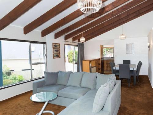 a living room with a couch and a table at Central Spacious Family House - Paihia House in Paihia