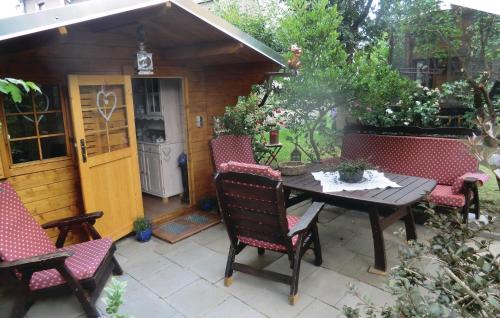 a patio with a table and chairs in front of a shed at Nice Apartment In Bad Schlema Ot Wildb in Schneeberg
