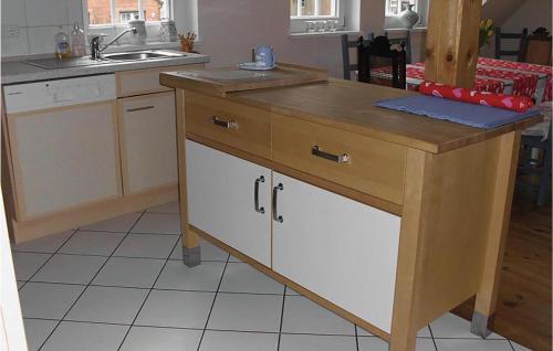 a kitchen with a wooden island in the middle at Stunning Apartment In Altenmedingen in Altenmedingen