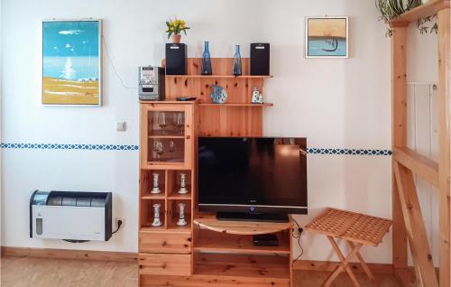 ein Wohnzimmer mit einem TV auf einem Holzständer in der Unterkunft Ferienhaus M�lschower Weg X in Trassenheide