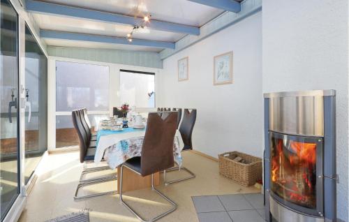 a dining room with a table and a fireplace at Stunning Home In Auerbachot Rempesgrün in Auerbach