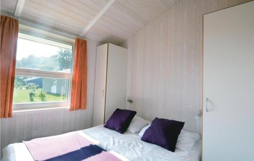 a small bedroom with a bed and a window at Strandblick 2 in Schönhagen