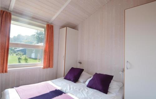 a bedroom with two beds and a window at Strandpark 14 in Schönhagen