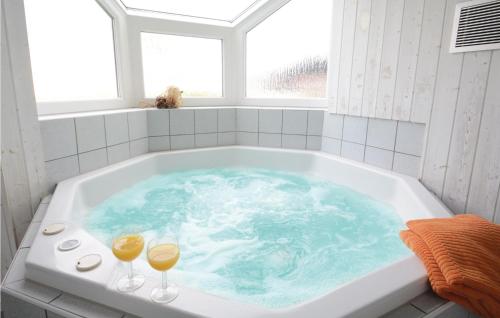 a bath tub with two glasses of wine in it at Strandblick 21 - Dorf 1 in Travemünde