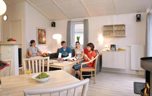 a group of people sitting around a table in a kitchen at Freibeuterweg 9 - Dorf 5 in Travemünde