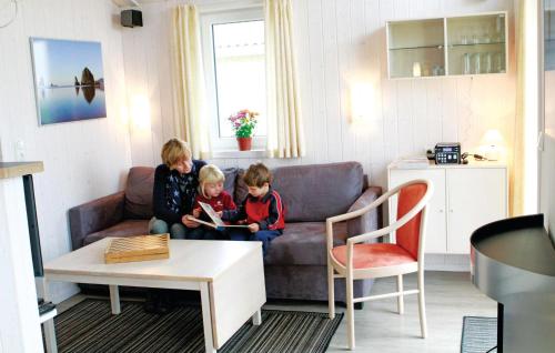 two children sitting on a couch in a living room at Friedrichskoog-Deichblick 9 in Friedrichskoog