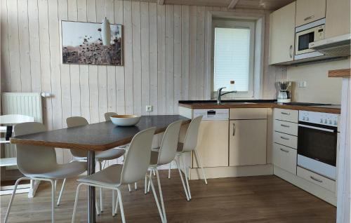 a kitchen with a table and chairs in a room at Friedrichskoog-Deichblick 14 in Friedrichskoog