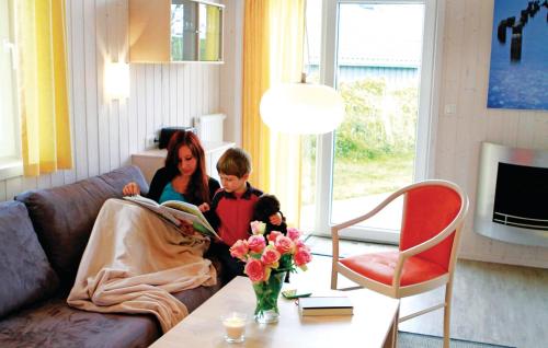 a woman and a child sitting in a living room at Friedrichskoog-Deichblick 11 in Friedrichskoog