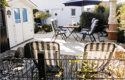 two chairs and an umbrella on a patio at Haus Seeadler 5 in Süssau