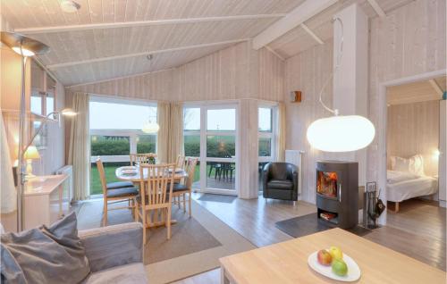 a living room with a table and a fireplace at Friedrichskoog-Strandpark 22 in Friedrichskoog