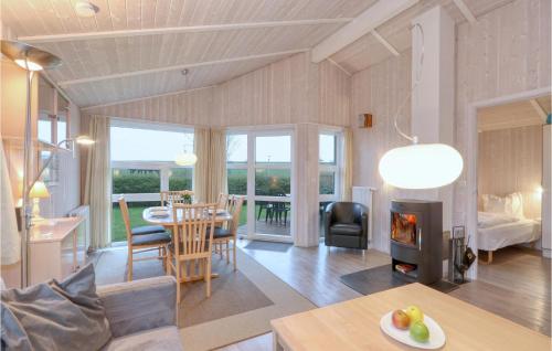 a living room with a table and a fireplace at Friedrichskoog-Strandpark 24 in Friedrichskoog