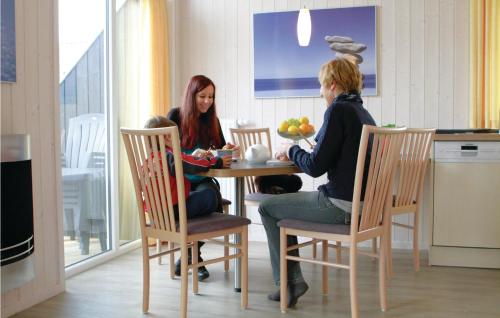 two women sitting at a table in a kitchen at Friedrichskoog-Deichblick 5 in Friedrichskoog