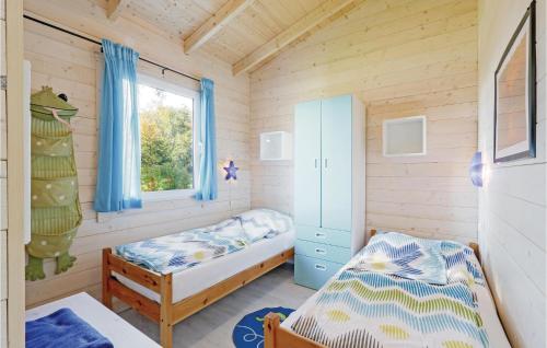 a small bedroom with two beds and a window at Seelwe in Süssau