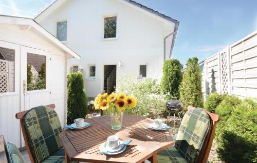 a wooden table and chairs on a patio at Haus Seeadler 1 in Süssau