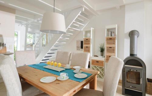 a dining room with a table and a fireplace at Haus Seeadler 1 in Süssau