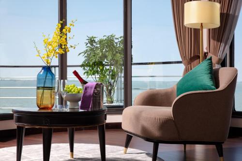 a living room with a chair and a table at Mon Cheri Cruises in Ha Long